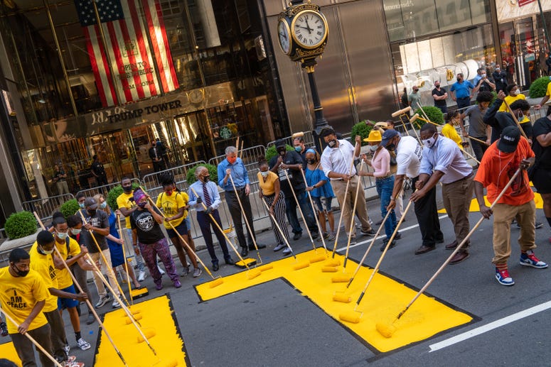 Mayor Bill de Blasio, his wife Chirlane McCray and Rev. Al Sharpton help paint a Black Lives Matter mural on Fifth Avenue directly in front of Trump Tower on July 9, 2020 in New York City. Black Lives Matter mural Trump Tower