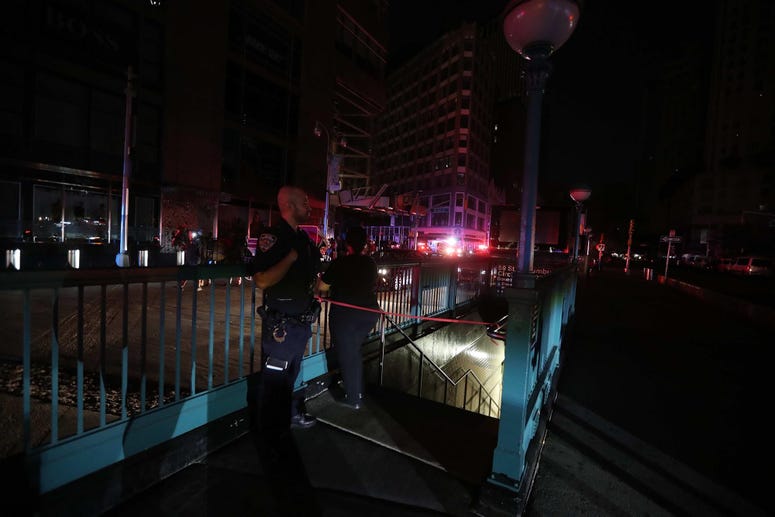 A member of the NYPD stands by a closed subway station at Columbus Circle in Manhattan was closed as subways were shut down after a power outage left large parts of the West Side of Manhattan without power July 13, 2019. NYC power outage