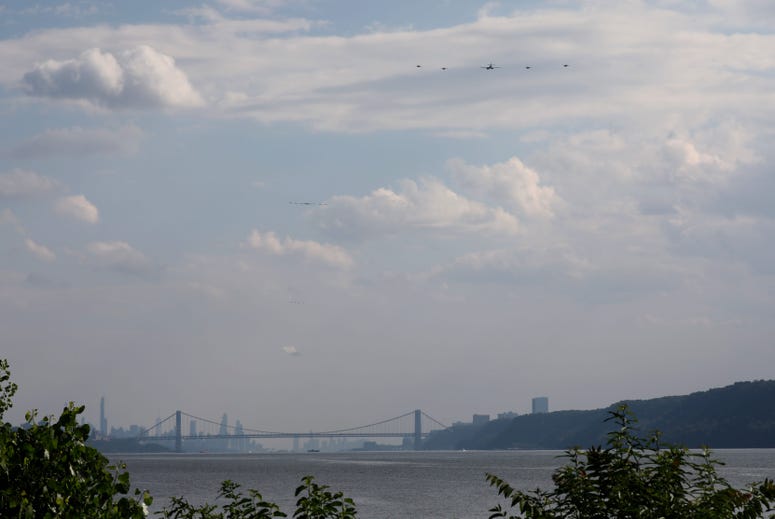 United States military aircraft fly above the Hudson River, as seen from Yonkers, during a \"Salute to Great Cities of the American Revolution\" flyover, July 4, 2020. NYC flyover