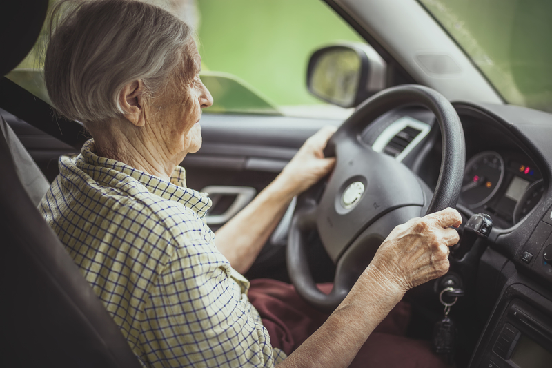 An older woman behind the wheel An older woman behind the wheel