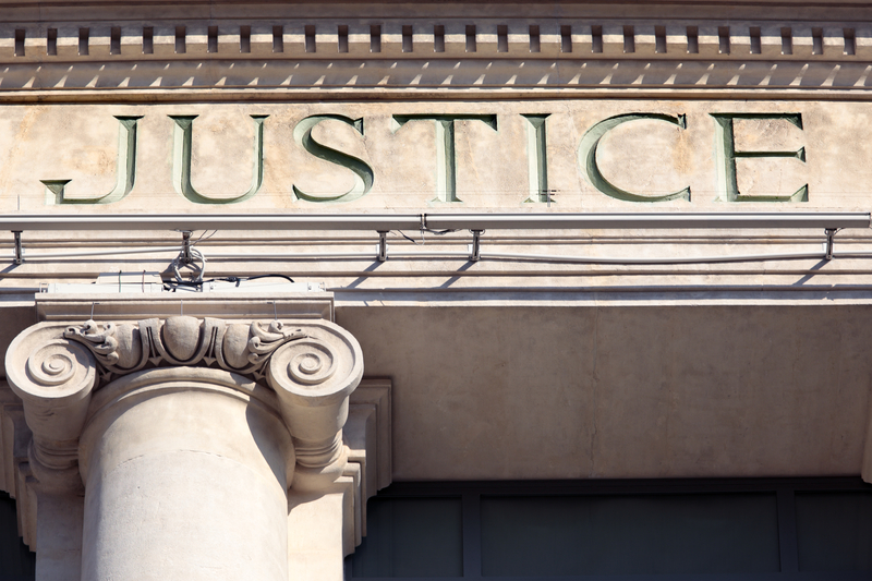 Justice sign on a Courtroom Building. Justice sign on a Courtroom Building.