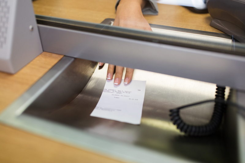 Clerk giving receipt at bank. Clerk giving receipt at bank.