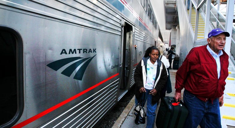 Passengers step off of an Amtrak train. Passengers step off of an Amtrak train.