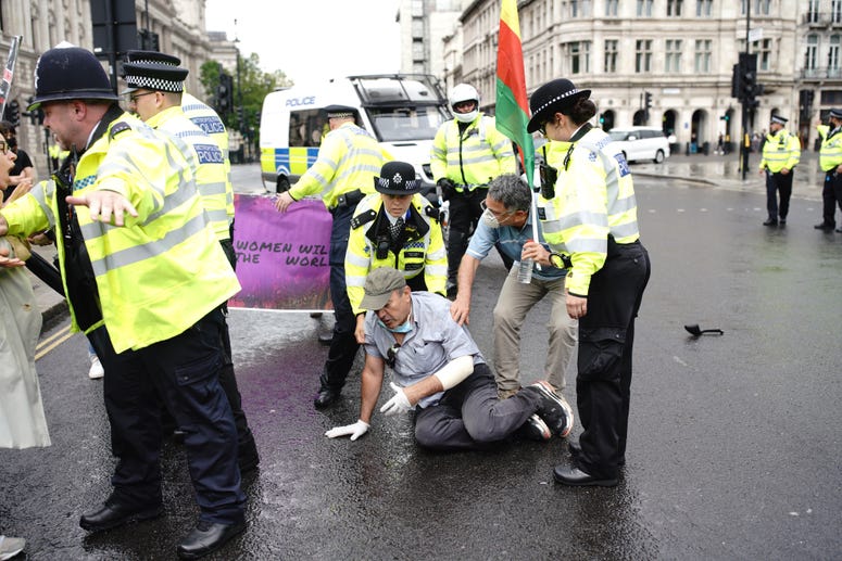 Police detain a man after he ran in front of Prime Minister Boris Johnson's car as it left the Houses of Parliament, Westminster. Boris Johnson vehicle