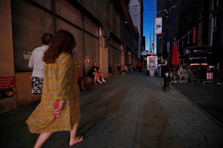 People walk in midtown Manhattan during a widespread power outage, Saturday, July 13, 2019, in New York. NYC blackout