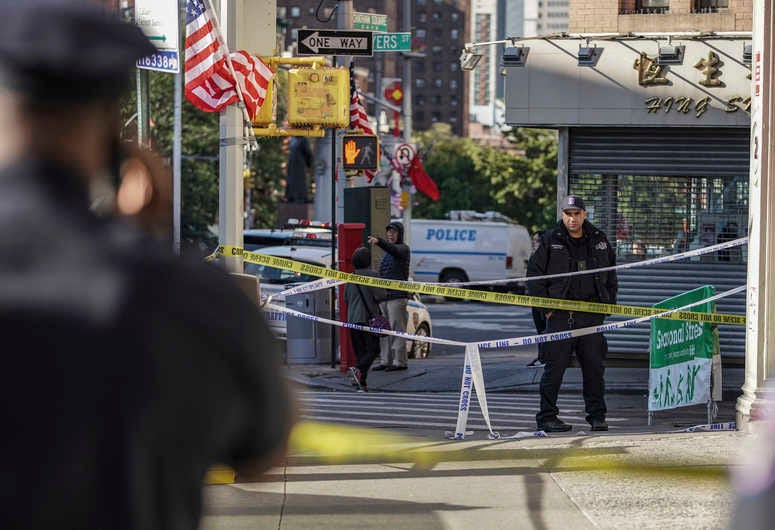 New York Police Department officers investigate the scene of an attack in Manhattan's Chinatown neighborhood, Saturday, Oct. 5, 2019 in New York. Homeless men attacked