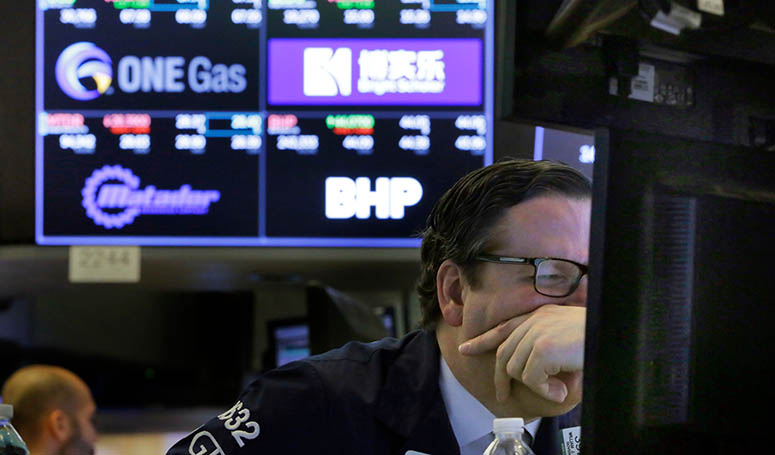 Specialist Gregg Maloney works on the floor of the New York Stock Exchange