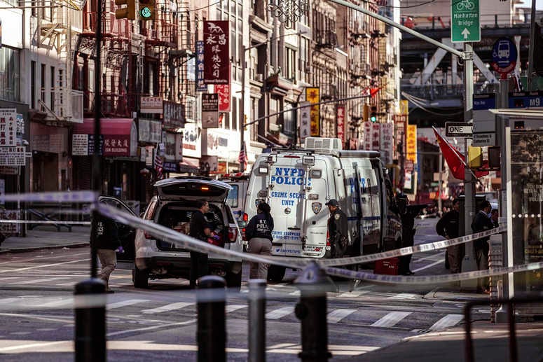 NYPD officers investigate the scene of an attack in Manhattan's Chinatown neighborhood, Saturday, Oct. 5, 2019 in New York. Homeless men attacked