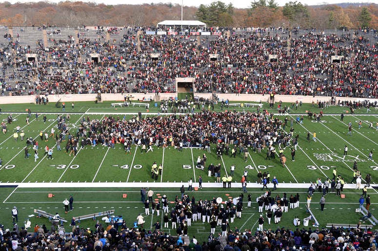 Demonstrators stage a climate change protest at the Yale Bowl delaying the start of the second half of an NCAA college football game between Harvard and Yale Saturday, Nov. 23, 2019, in in New Haven, Conn. Climate protest