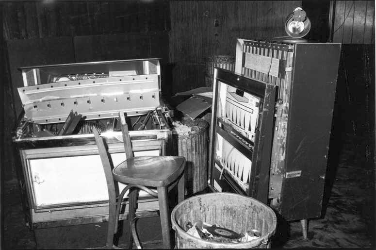 View of a damaged jukebox and cigarette machine, along with a broken chair, inside the Stonewall Inn (53 Christopher Street) after riots over the weekend of June 27, 1969. (Photo by Fred W. McDarrah/Getty Images)