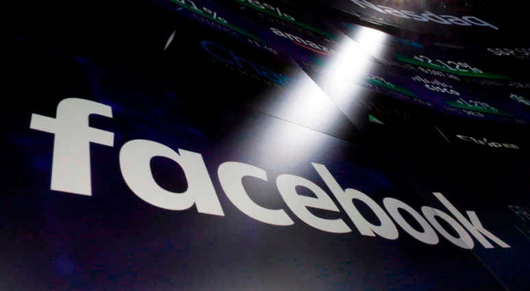 The logo for Facebook appears on screens at the Nasdaq MarketSite in New York's Times Square in March 2018. Facebook