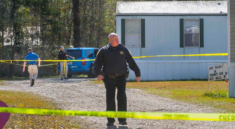 Investigators work the scene of a shooting in Livingston Parish in Louisiana. Authorities in Louisiana say a shooting has left five people dead in two parishes. Louisiana shooting