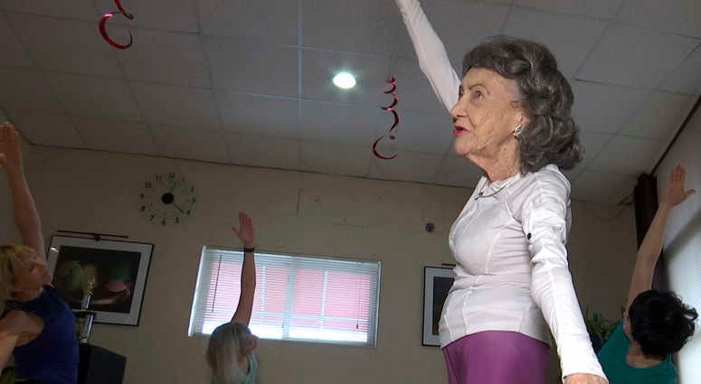 In this April 5, 2019, image made from a video, 100-year-old Tao Porchon-Lynch teaches a yoga class in Hartsdale, N.Y. 100-year-old yoga instructor
