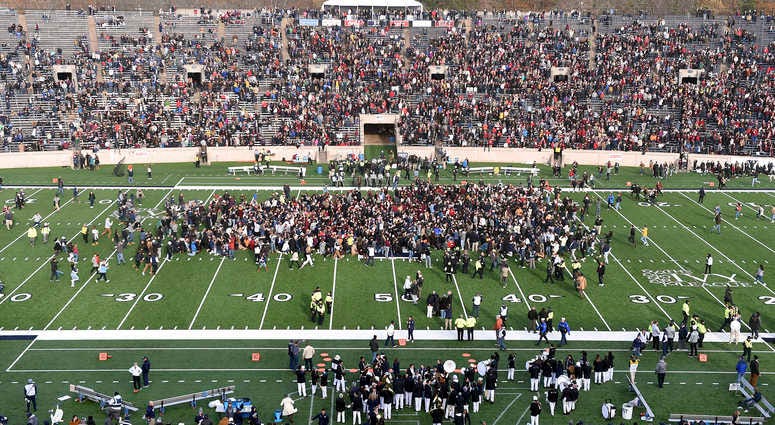 Demonstrators stage a climate change protest at the Yale Bowl delaying the start of the second half of an NCAA college football game between Harvard and Yale Saturday, Nov. 23, 2019, in in New Haven, Conn. Climate protest