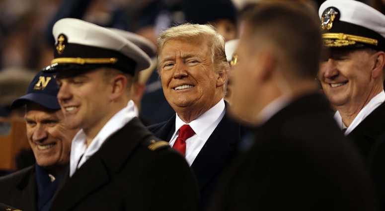 President Donald Trump stands with Naval Academy Midshipmen during halftime of the 119th Army-Navy game at Lincoln Financial Field. President Trump