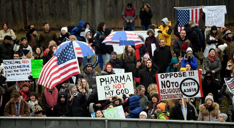 Anti-vaccination protesters stand outside of the New Jersey State House as the Assembly passes a bill to limit vaccine religious exemptions on Monday, Dec. 16, 2019, in Trenton. Vaccines New Jersey