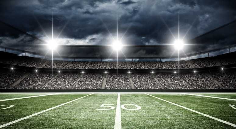 A football field under stadium lights