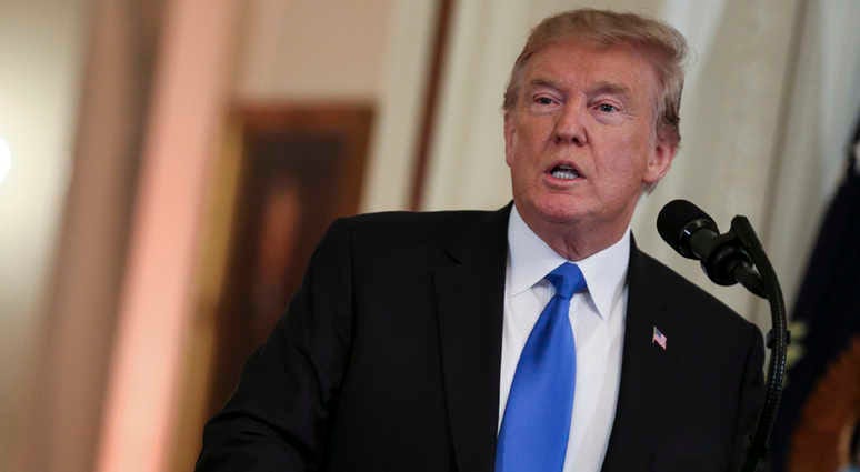 President Donald Trump speaks in the East Room of the White House. Trump