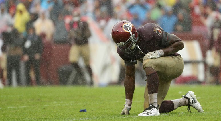 Adrian Peterson reacts after fumbling the ball on the rain-soaked FedEx Field in the third quarter against the 49ers A miserable Redskins season trudges on