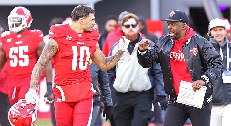 Defenders receiver Simmie Cobbs Jr. celebrates the team's 27-0 blowout win over the New York Guardians with head coach Pep Hamilton XFL has a niche, but it's small ball