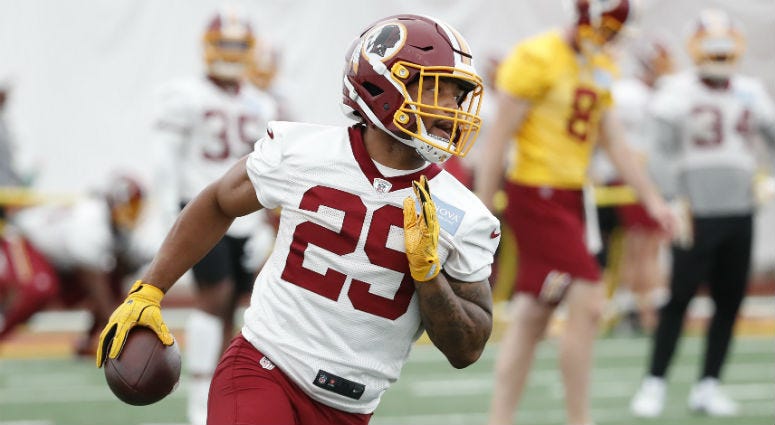Derrius Guice could miss the start of training camp with a hamstring injury. Redskins RB Derrius Guice carries the ball during a practice drill.