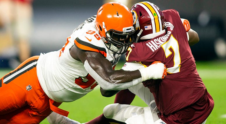 Redskins rookie Dwayne Haskins sacked by Browns defensive lineman Devaroe Lawrence in the second quarter of Washington's preseason opener in Cleveland Dwayne Haskins shows flashes, throws 2 interceptions in NFL debut