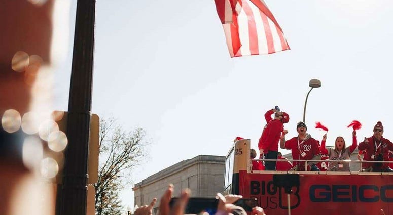 That's Grant. On top of a parade bus, drinking a cold one. Grant Paulsen and Danny Rouhier of the "Grant & Danny Show" take part in the Washington Nationals victory parade in Washington, D.C. on Saturday, November 1.