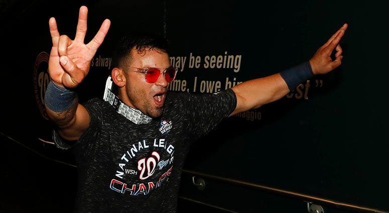 Gerardo Parra runs down the tunnel to celebrate winning the NL Pennant in the clubhouse Gerardo Parra celebrates winning the NL pennant
