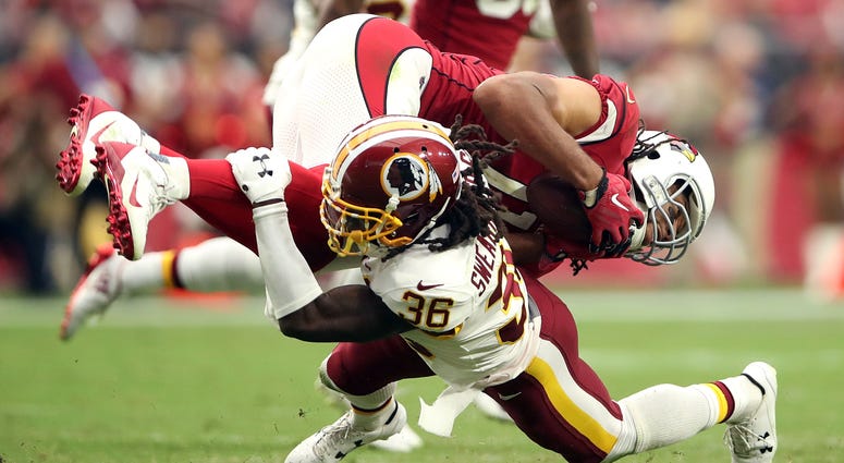 D.J. Swearinger tackles Cardinals receiver Larry Fitzgerald low DJ_Swearinger_Larry_Fitzgerald