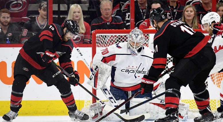 A pair of Hurricanes battle for position in front of Braden Holby's net. Capitals_Hurricanes