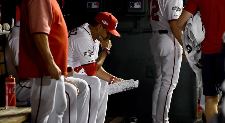 Davey Martinez contemplating a change during Wild Card Game. PHOTOS: Stay in the fight! Nats beat Brewers in Wild Card