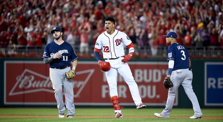 Juan Soto is tagged out, but he doesn't care. PHOTOS: Stay in the fight! Nats beat Brewers in Wild Card