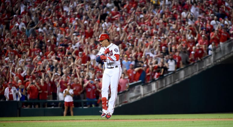 Juan Soto celebrates RBI single during rundown. PHOTOS: Stay in the fight! Nats beat Brewers in Wild Card