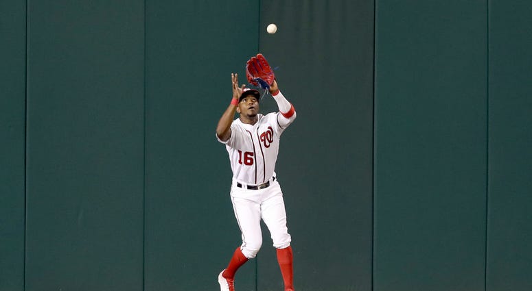 Victor Robles catches final out in center field. PHOTOS: Stay in the fight! Nats beat Brewers in Wild Card