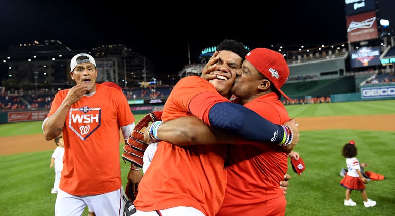 Juan Soto gets a hug from his dad after Wild Card Game win. Photos: Stay in the fight! Nats beat Brewers in Wild Card