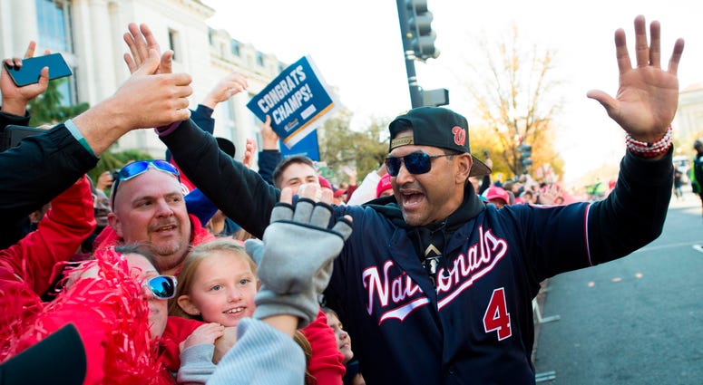 Nats manager Davey Martinez with fans at the Nats' parade. Photos of Nationals' World Series parade are insane