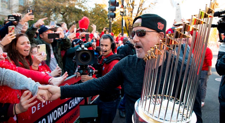 Nats GM Mike Rizzo and the World Series trophy. Photos of Nationals' World Series parade are insane