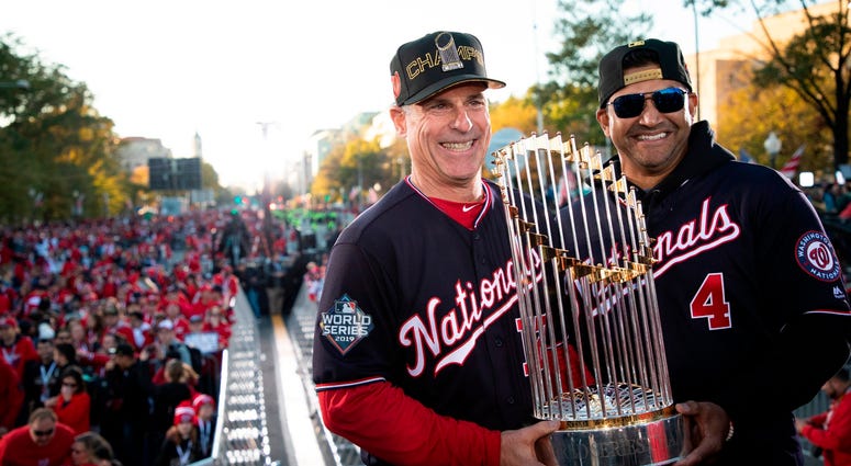 Chip Hale and Dave Martinez with the World Series trophy. Photos of Nationals' World Series parade are insane