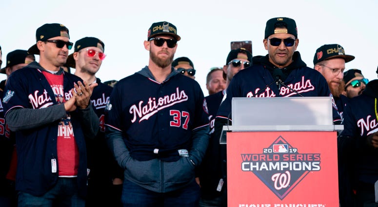 Manager Dave Martinez, Stpehen Strasburg, and Ryan Zimmerman at World Series parade. Photos of Nationals' World Series parade are insane