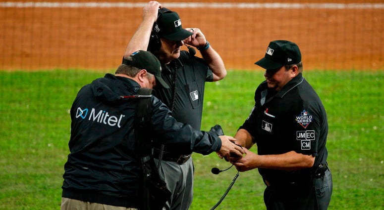 Umpires got on headsets to review call at first base in Game 6. Best pictures of World Series umpire controversy, Dave Martinez ejection