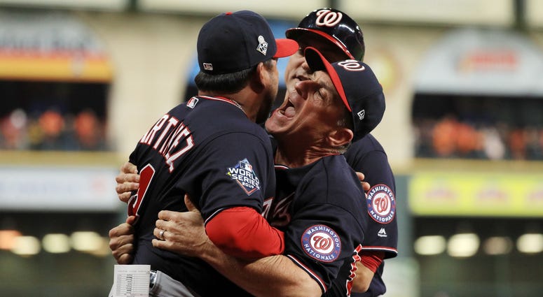 Bob Henley helps hold back Davey Martinez. Best pictures of World Series umpire controversy, Dave Martinez ejection