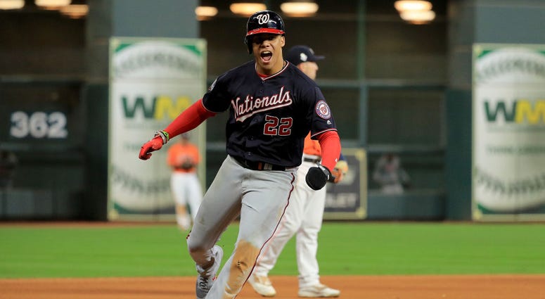 Juan Soto celebrates as he rounds the bases following Howie Kendrick's game-altering home run. Juan Soto #22 of the Washington Nationals celebrates as he comes home to score a run on a home run by Howie Kendrick (not pictured) against the Houston Astros during the seventh inning in Game Seven of the 2019 World Series.