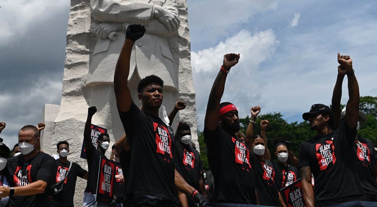 Rui Hachimura, John Wall and Bradley Beal of the Wizards hold their fists in the air in front of the Martin Luther King, Jr. Memorial in Washington, D.C. DC's Juneteenth march to the Martin Luther King, Jr. Memorial