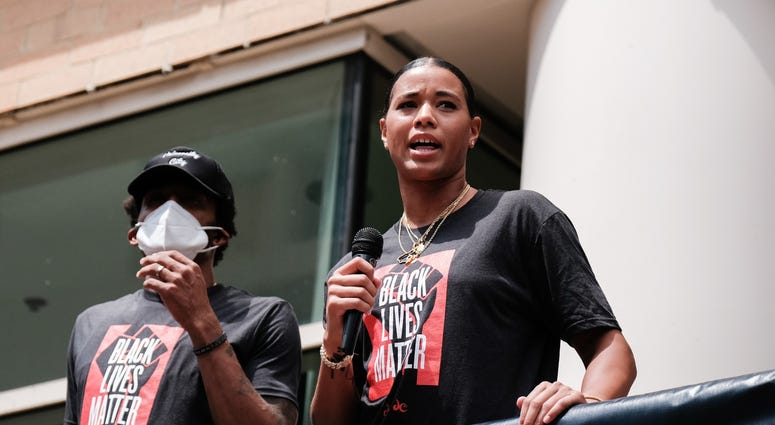 Natasha Cloud of the Washington Mystics speaks at a Juneteenth rally to raise awareness for social justice issues DC's Juneteenth march to the Martin Luther King, Jr. Memorial