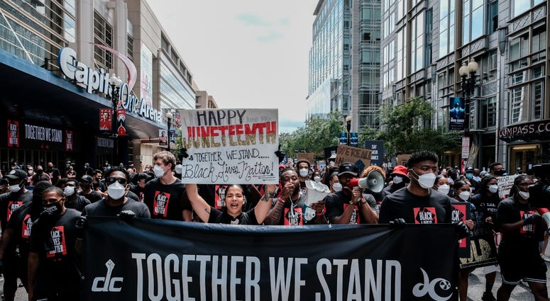 Members of the Washington Wizards and Washington Mystics march to the MLK Memorial to support Black Lives Matter and to mark the liberation of slavery DC's Juneteenth march to the Martin Luther King, Jr. Memorial
