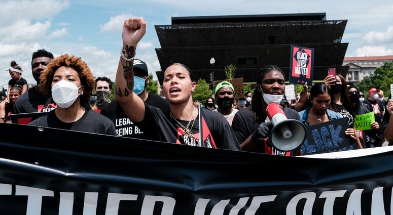 Natasha Cloud marches to the MLK Memorial, as the National Museum of African American History and Culture is seen in the background DC's Juneteenth march to the Martin Luther King, Jr. Memorial