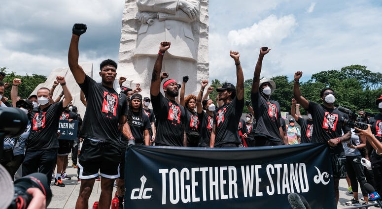From the left: Rui Hachimura, John Wall and Bradley Beal stand in front of the Martin Luther King, Jr. Memorial DC's Juneteenth march to the Martin Luther King, Jr. Memorial
