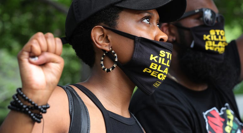 People kneel and raise their fists in the air for eight minutes and 46 seconds – the time that George Floyd was pinned under a police officer's knee – during a march and protest to mark the Juneteenth holiday at the Martin Luther King Jr. Memorial DC's Juneteenth march to the Martin Luther King, Jr. Memorial