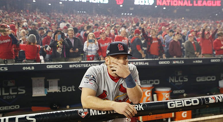 Cardinals outfielder Harrison Bader looks on stunned as the Nationals celebrate winning the National League pennant Harrison Bader