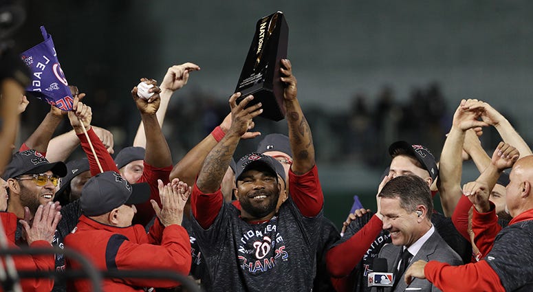 Howie Kendrick hoists the NLCS MVP trophy Howie Kendrick NLCS MVP